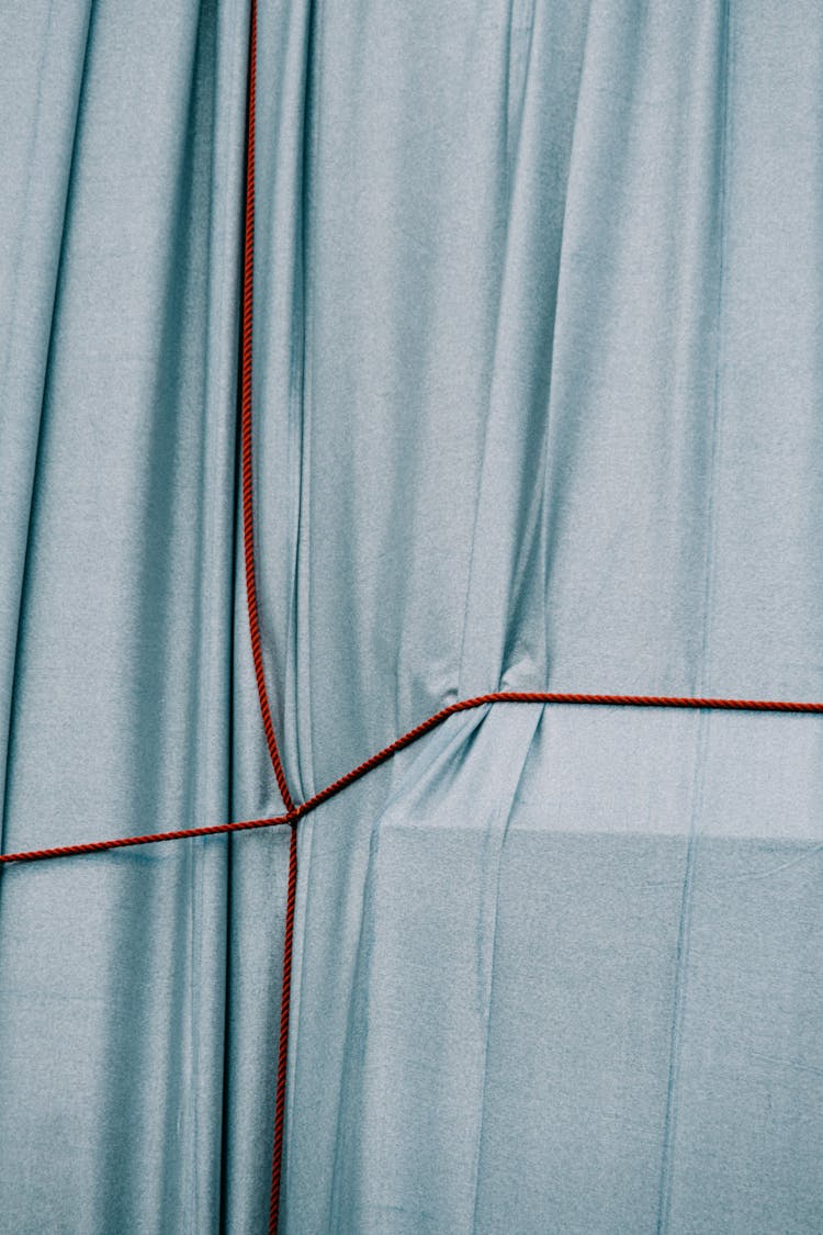 Blue Fabric With Red Strings Crossed