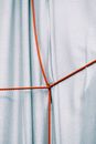 Blue fabric with red strings crossed