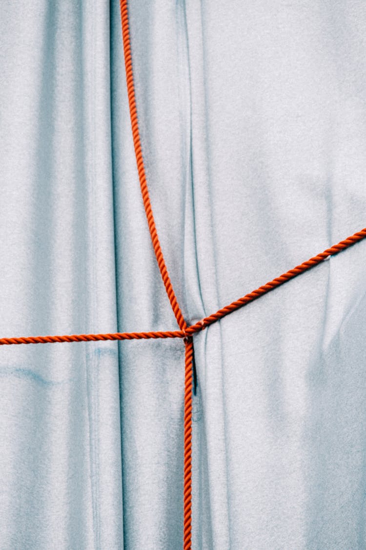 Blue Fabric With Red Strings Crossed