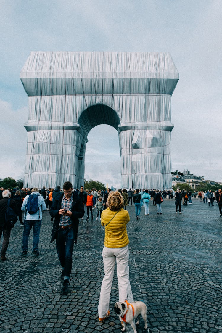 People Walking Near Modern Outdoor Monument Installation