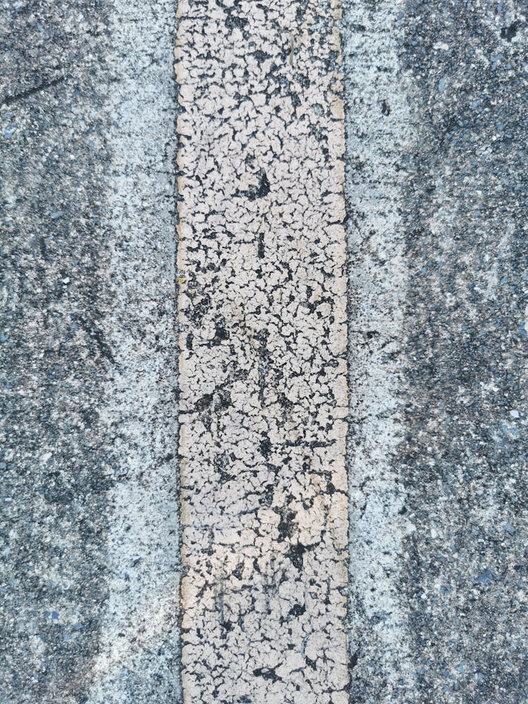 Closeup Of Weathered Road Marking With Rough Texture