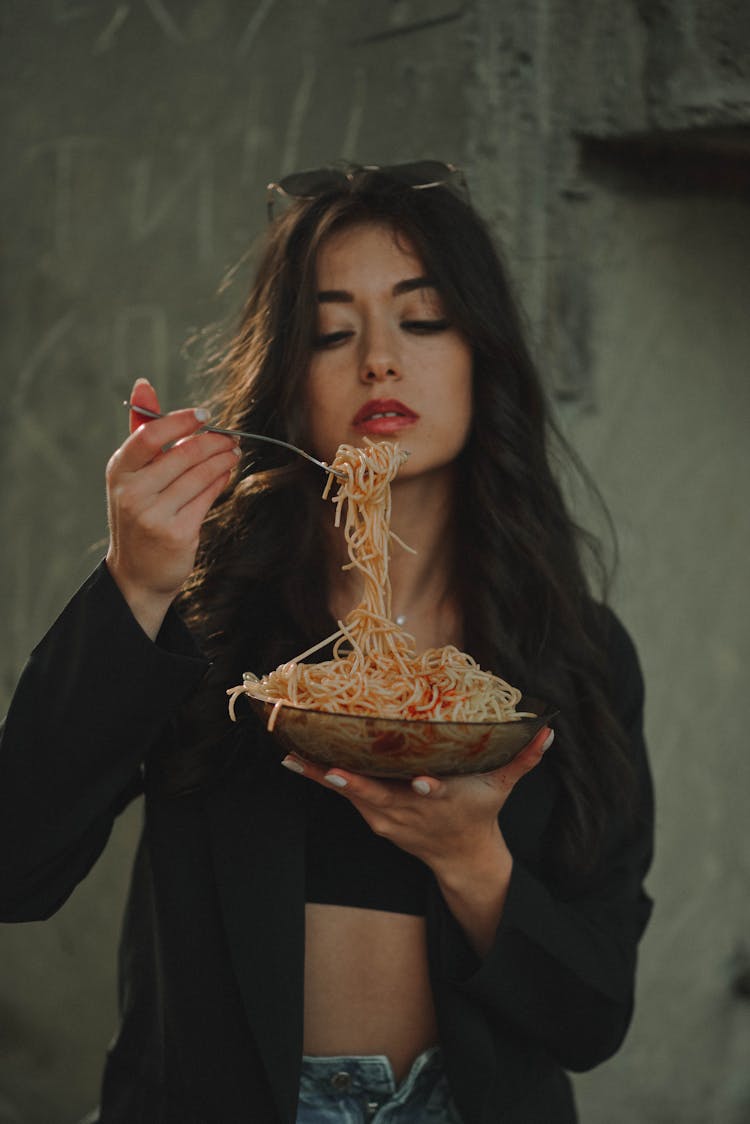 A Woman Eating Pasta