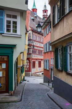 A vibrant narrow alleyway showcasing colorful traditional European architecture and cobblestone streets.