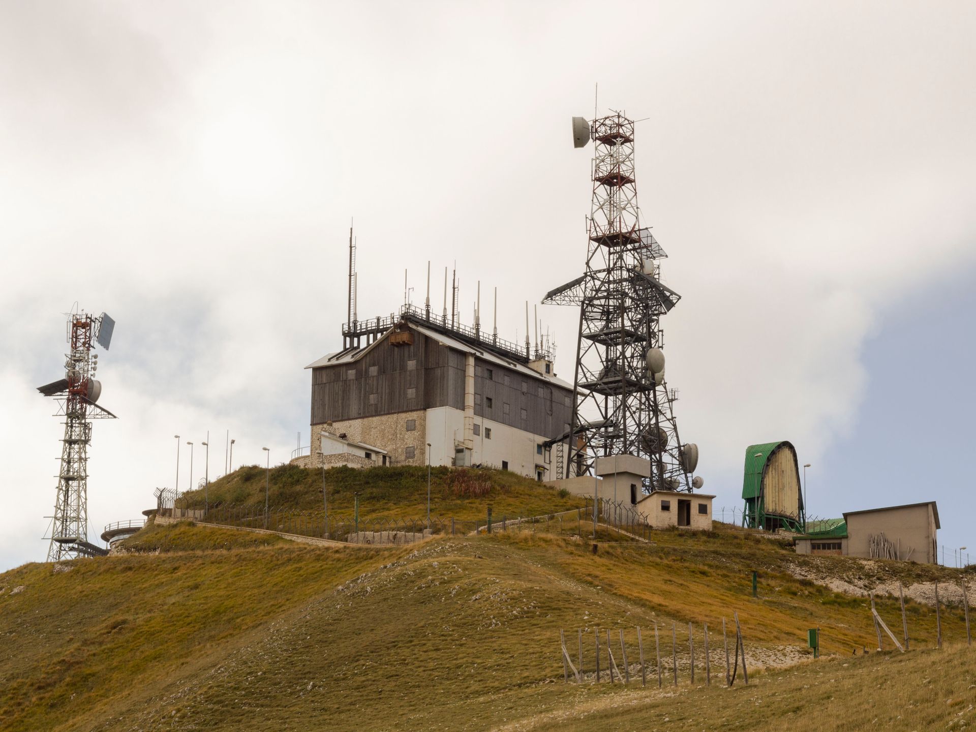 Telecommunication towers on a hill in Lazio, Italy, providing energy and connectivity.