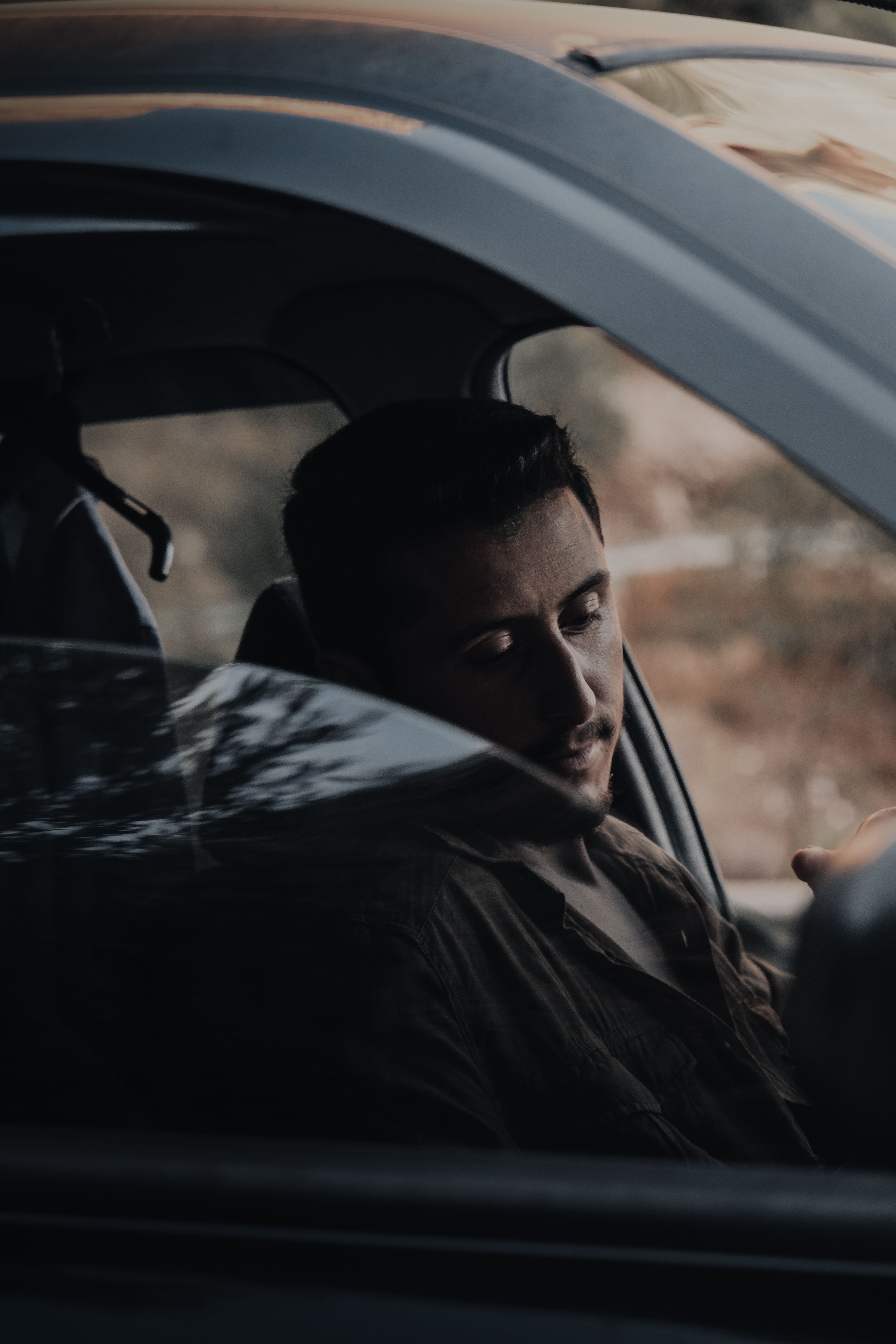 A Man Sitting Inside the Red Car · Free Stock Photo