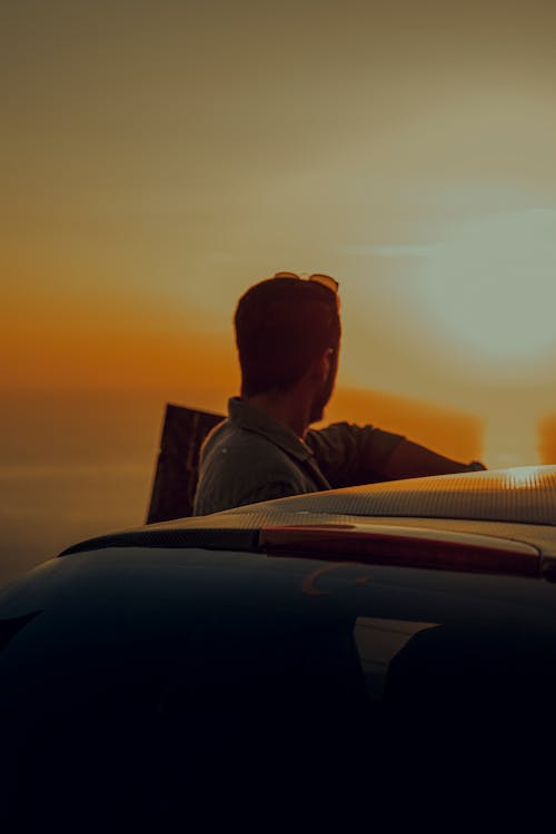 A Man Standing Near the Car