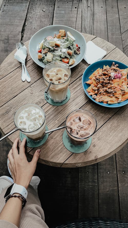 Free Overhead Shot of Food and Drinks on a Table Stock Photo