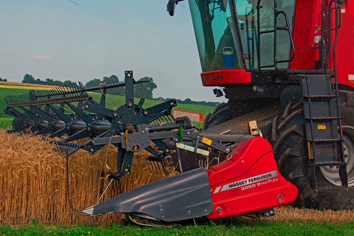 Red and Black Tractor on Brown Grass Field