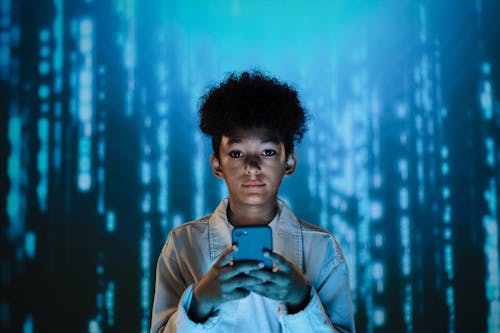 Free A Boy Using a Mobile Phone Stock Photo