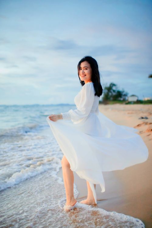 Woman in White Dress Standing on Beach · Free Stock Photo