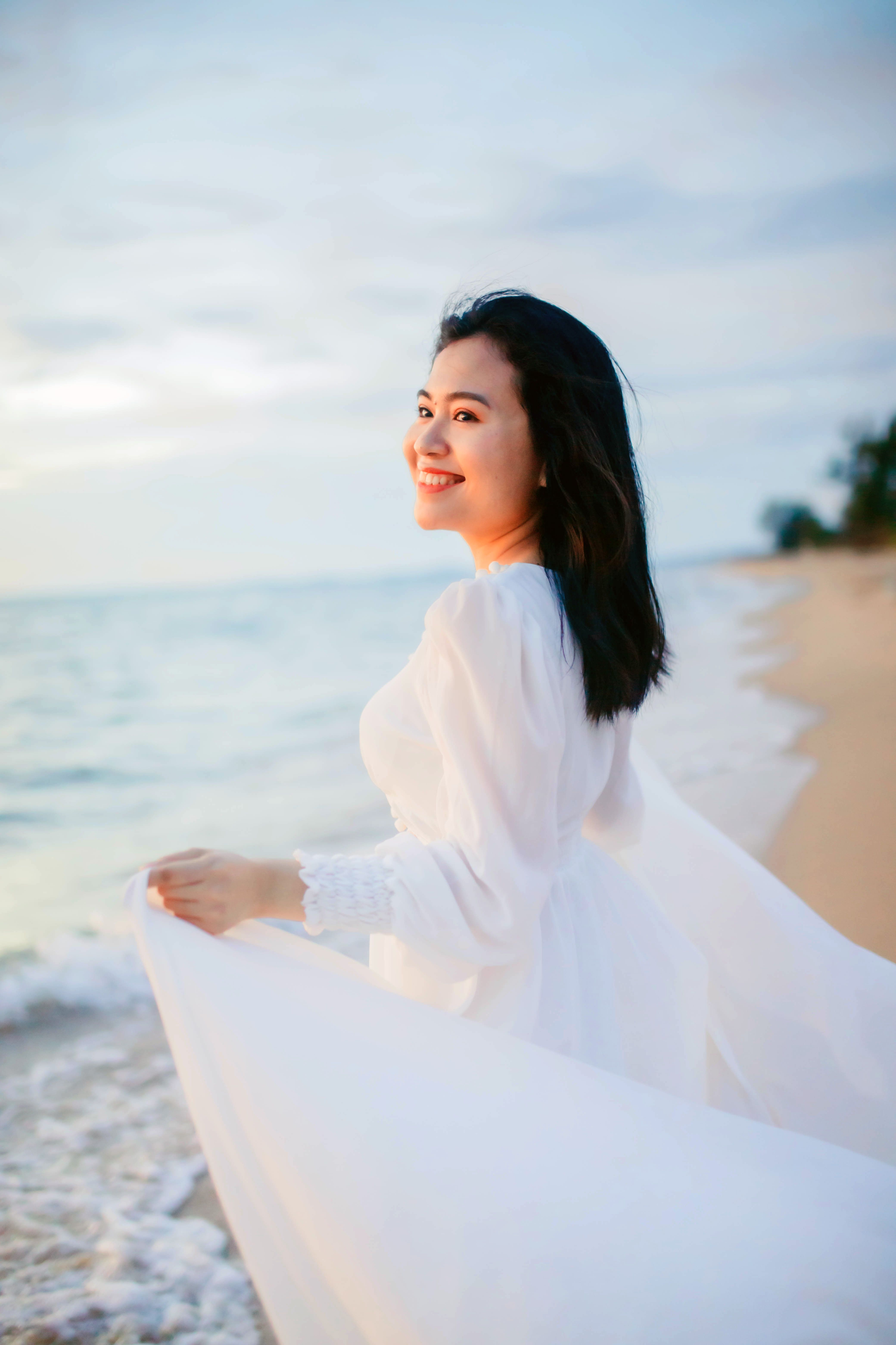A Woman in White Long Sleeve Dress · Free Stock Photo