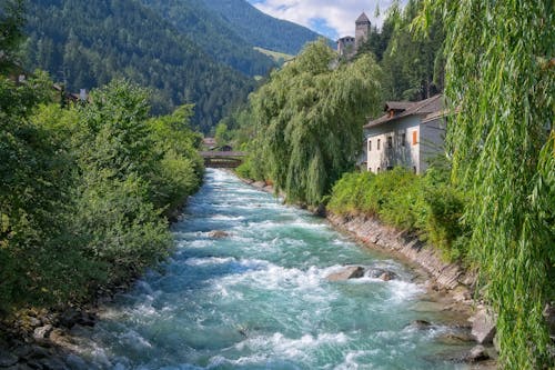 Free House Beside River in Mountains Stock Photo