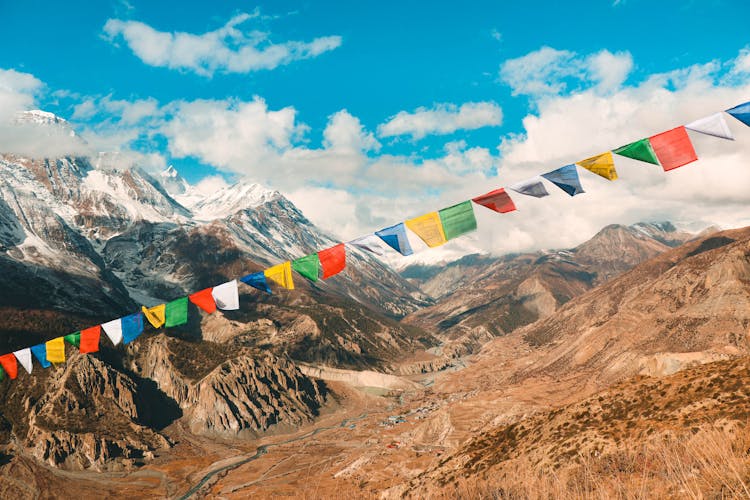 Colorful Flags On String In Mountains