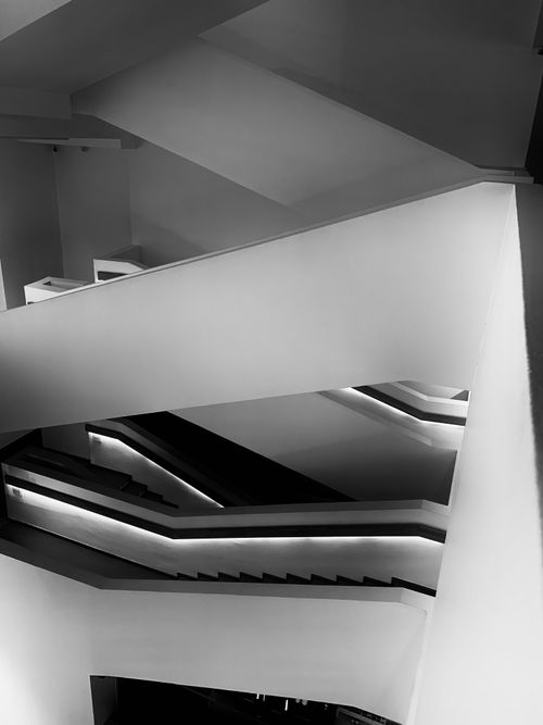 Free A modern black and white abstract photo of a geometrically complex staircase. Stock Photo