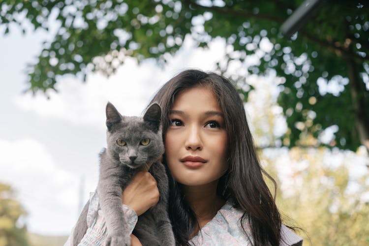 A Woman Carrying Her Cat