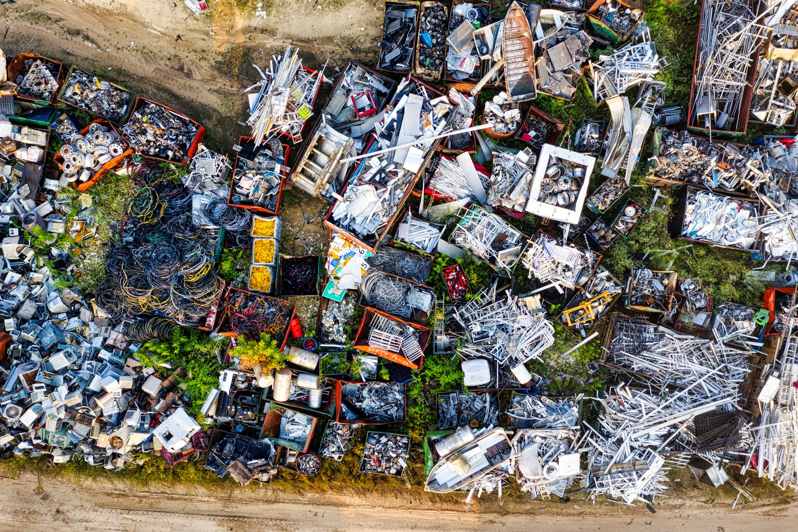 Aerial drone view of scrap metal piles in a recycling yard