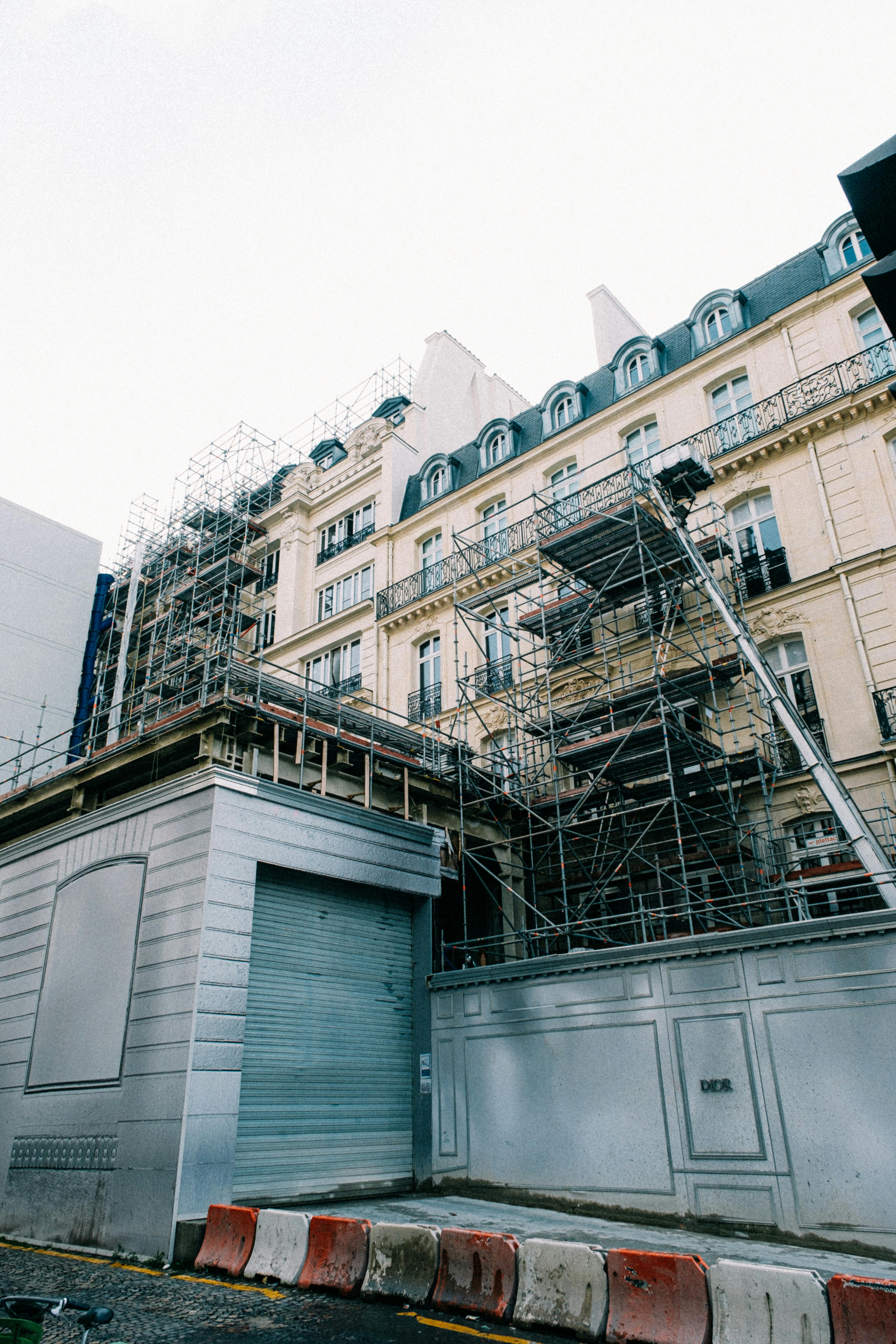 scaffolding installed on renovated wall of old building