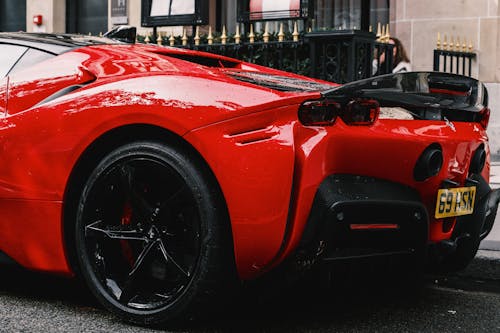 Red Ferrari Parked on Street Side