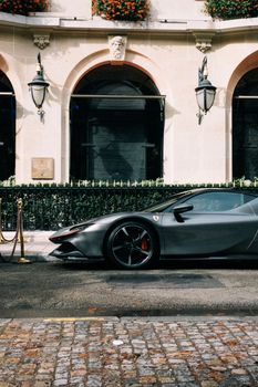 A sleek Ferrari sports car parked on a cobblestone street showcasing urban elegance.