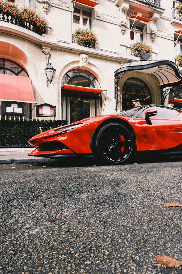 Red Ferrari Car Parked On The Road