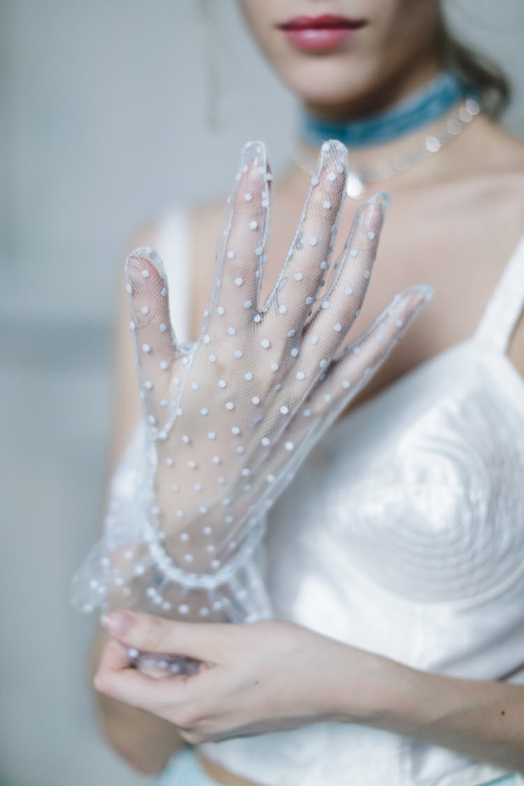 A Woman Wearing A Lace Glove