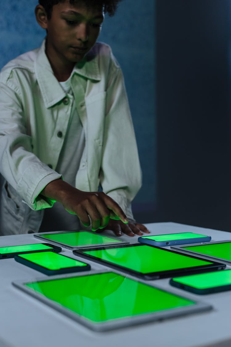 Boy Touching Gadgets With Blank Screen