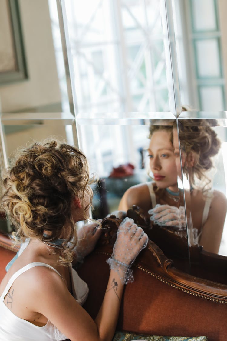 A Beautiful Woman Looking At Mirror