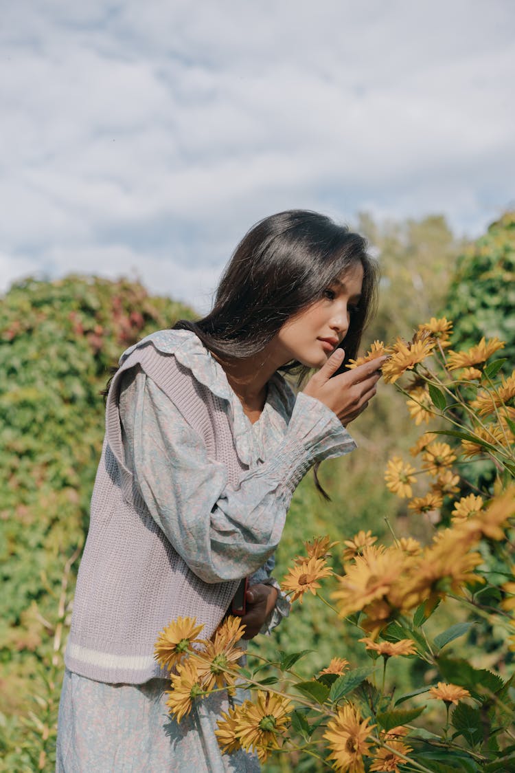 Pretty Woman Smelling The Flowers