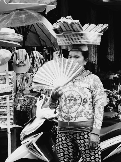 Grayscale Photo of Woman Holding Fan