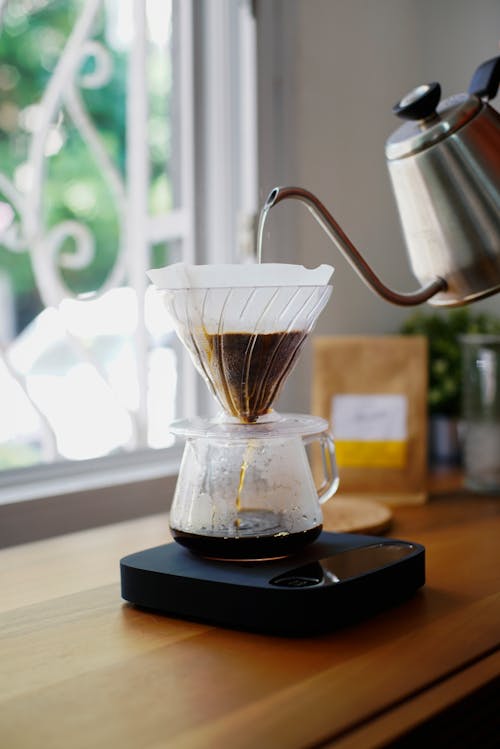 Free Close-up of Hot Water from a Pot being Poured into a Coffee Pot  Stock Photo