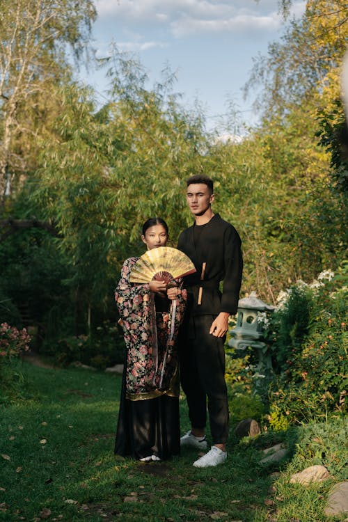 Young Woman in a Kimono and a Man Standing in a Garden 