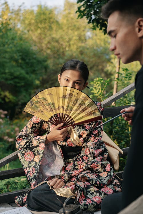 A Woman Sitting on the Wooden Bench