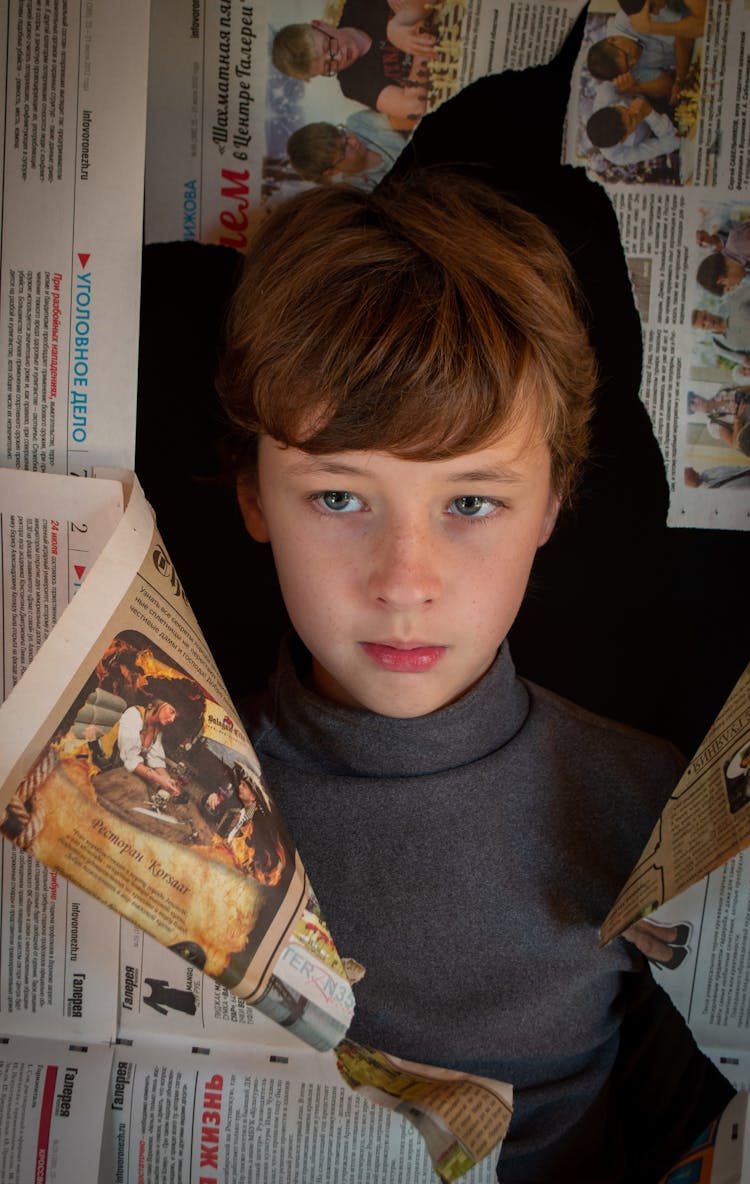 Boy In Hole In Newspapers