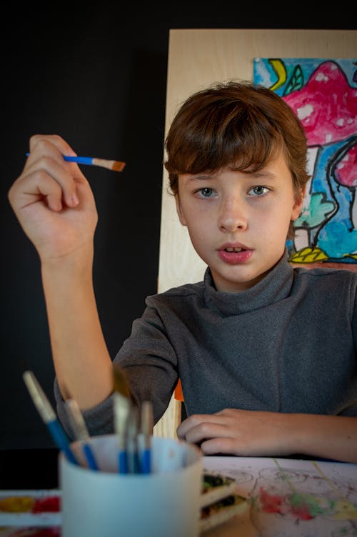 Photo of a Boy Holding a Paintbrush 