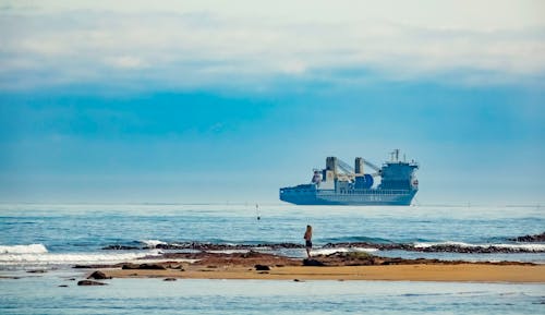 Blue Ship on Sea Under Blue Sky