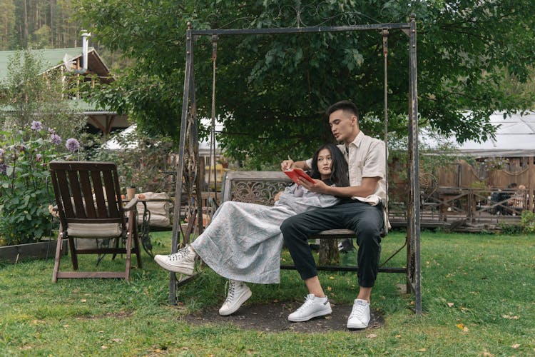 Romantic Couple Sitting On The Swing