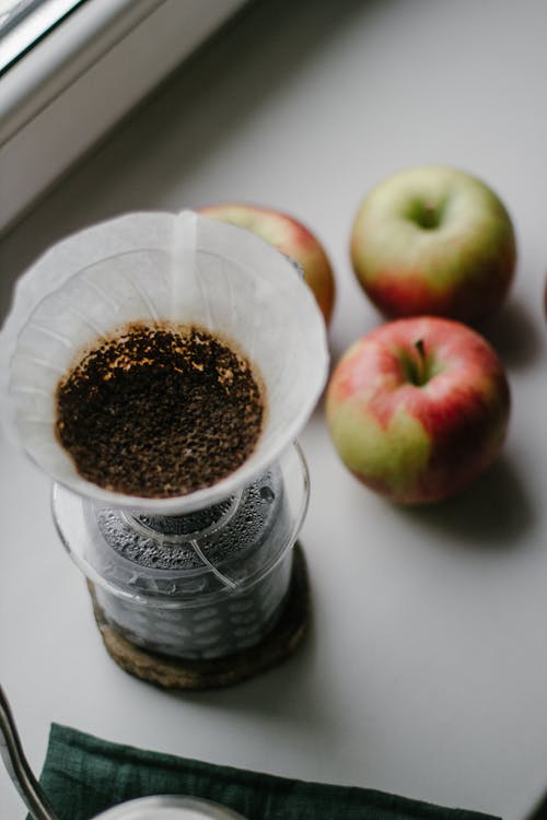  Apples Beside Clear Glass Container with Coffee Drip