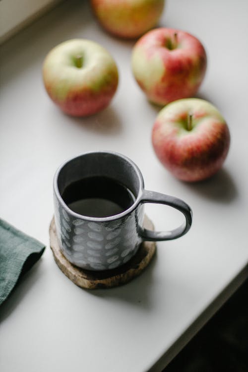 Apples beside a Cup of Coffee