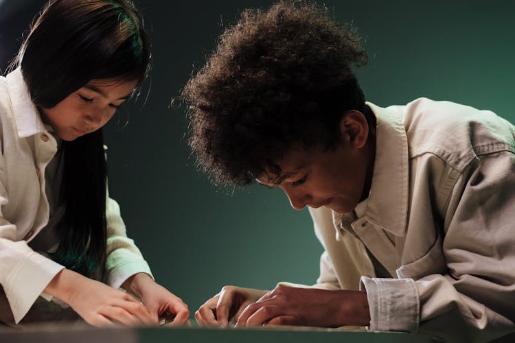 Two Teenagers Doing Jigsaw Puzzle