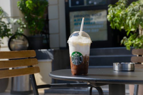 Free Starbucks Coffee Cup on Table Stock Photo
