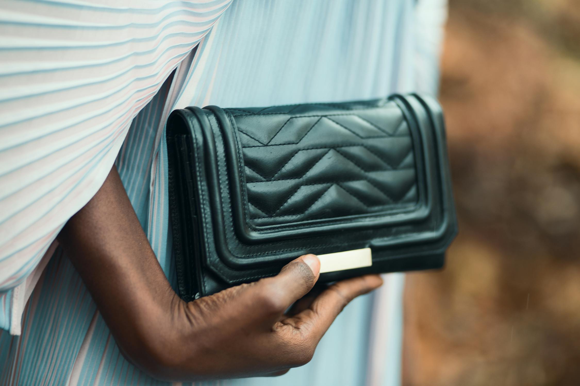 a woman holding a small purse