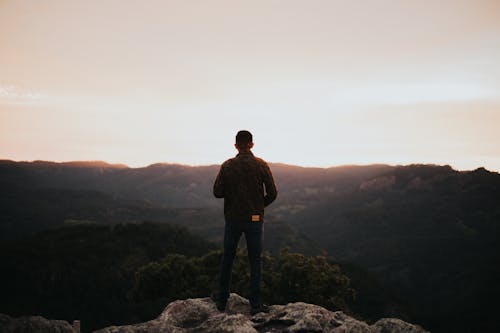 Free Man Standing on a Rock Stock Photo