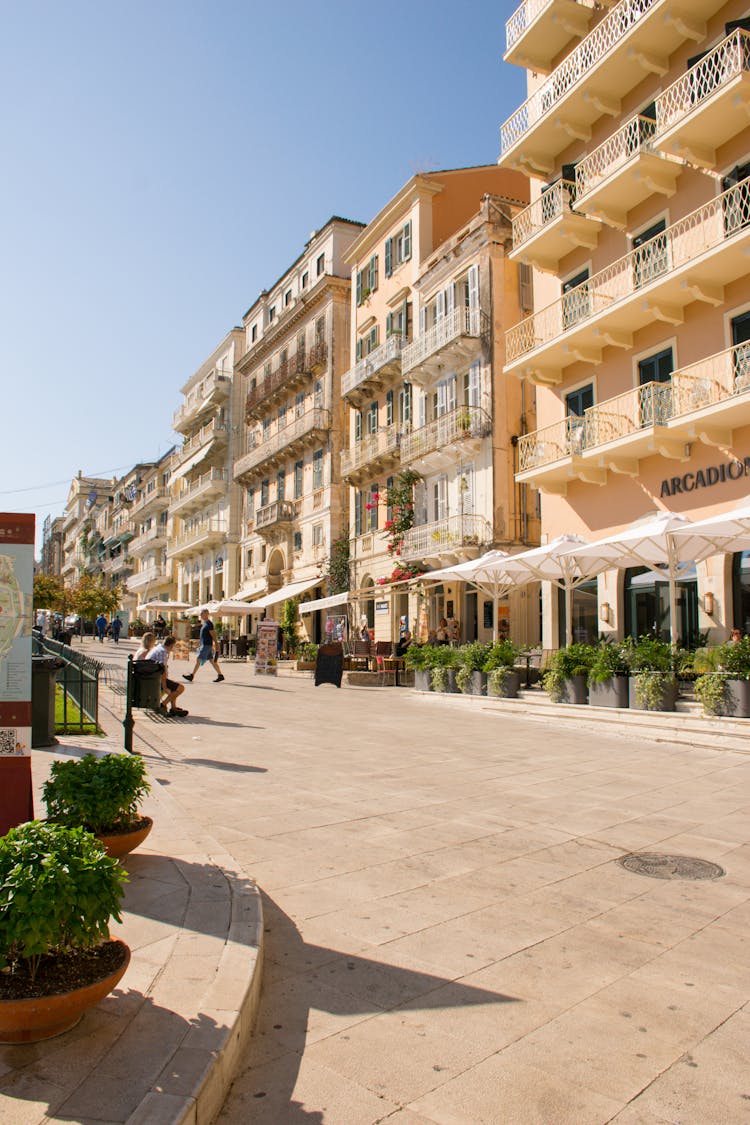 A Row Of Concrete Buildings Under The Clear Blue Sky 