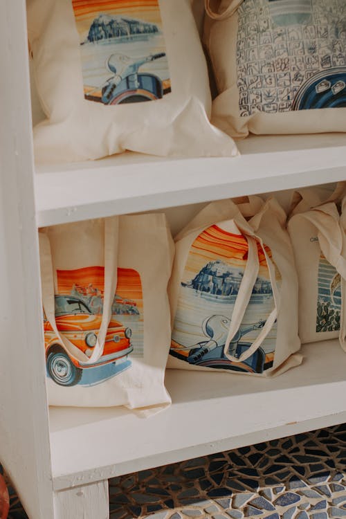 White Canvas Tote Bags on Wooden Shelf