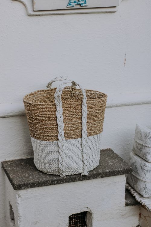 Free Artistic shot of a handcrafted woven basket with a white base. Perfect for decor ideas. Stock Photo