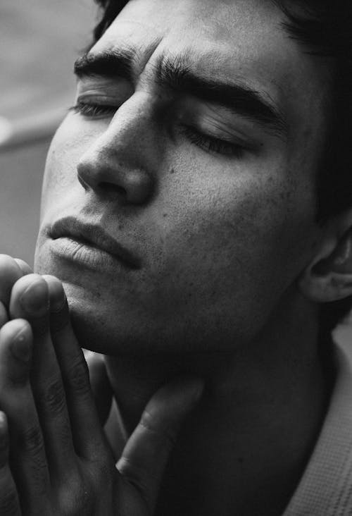 Black and white portrait of man praying