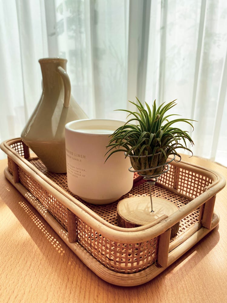 A Pitcher And A Mug In A Basket