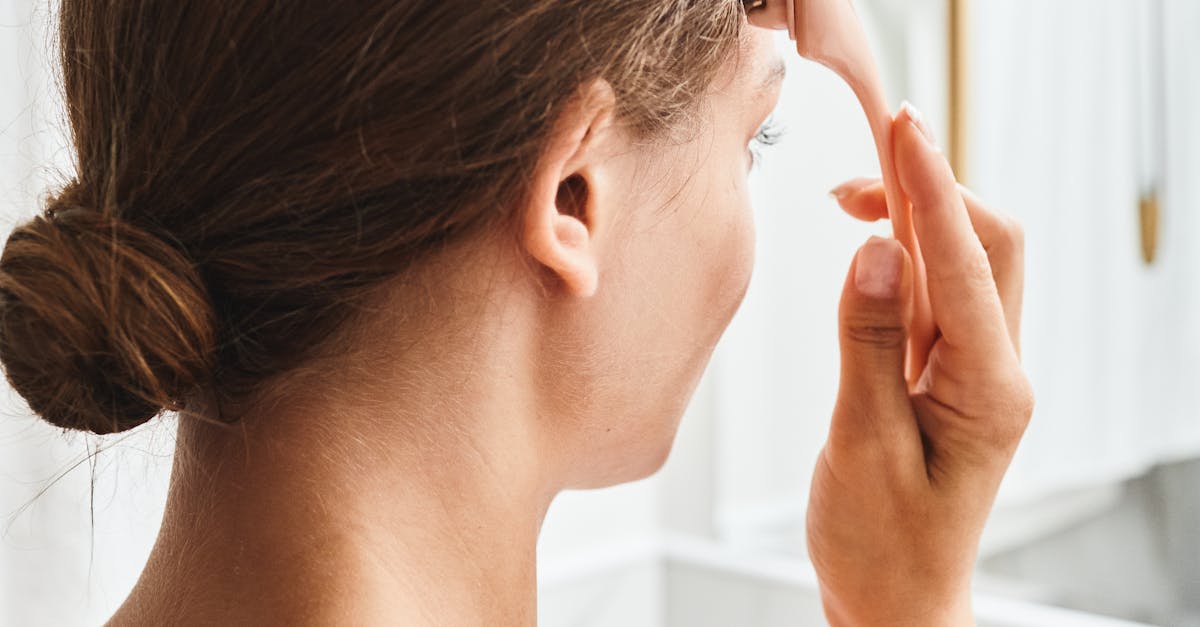 A person receiving reflexology foot massage on a reclining chair in a wellness center.