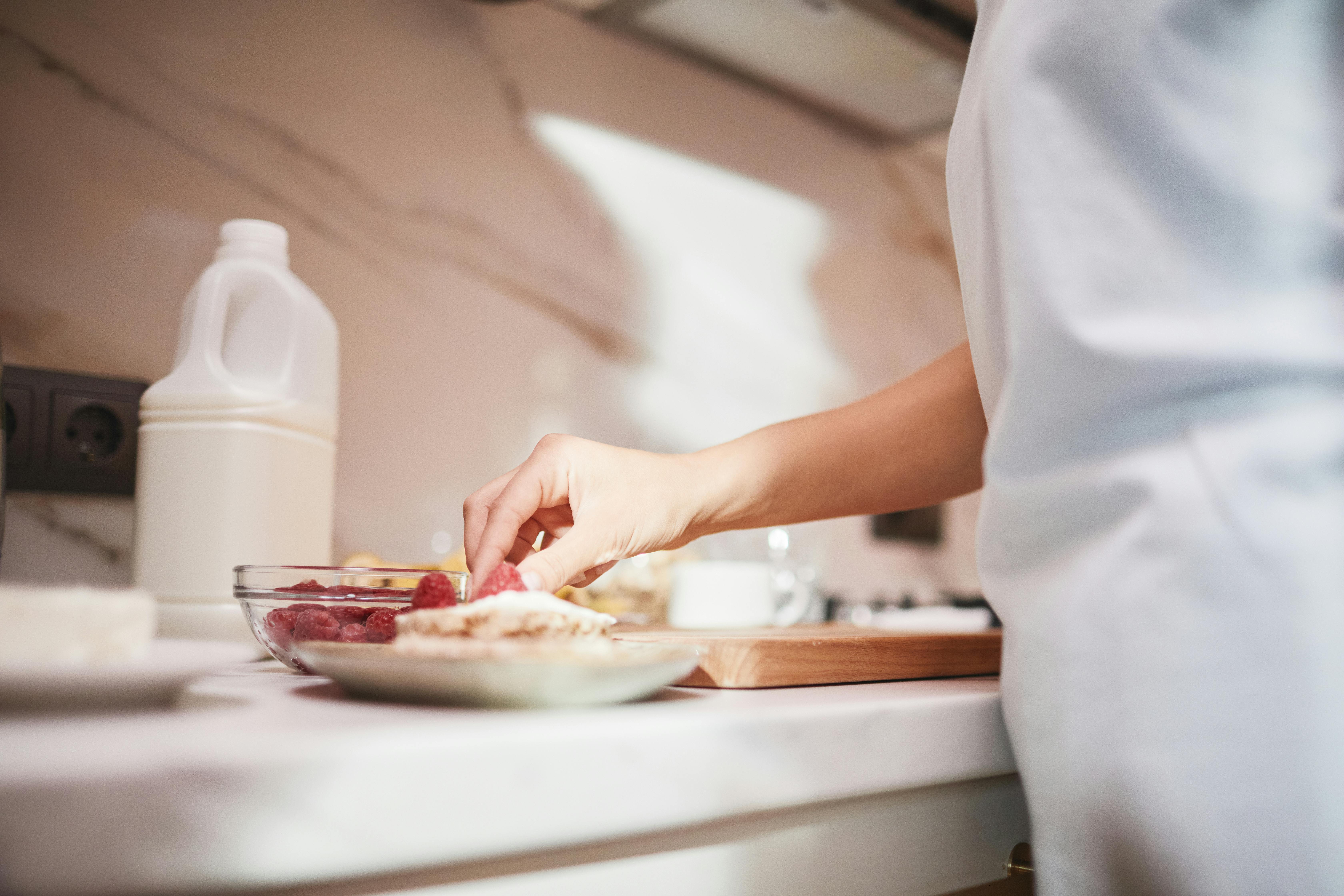 Large Yogurt Container With Fresh Fruit And Honey On A Kitchen Countertop