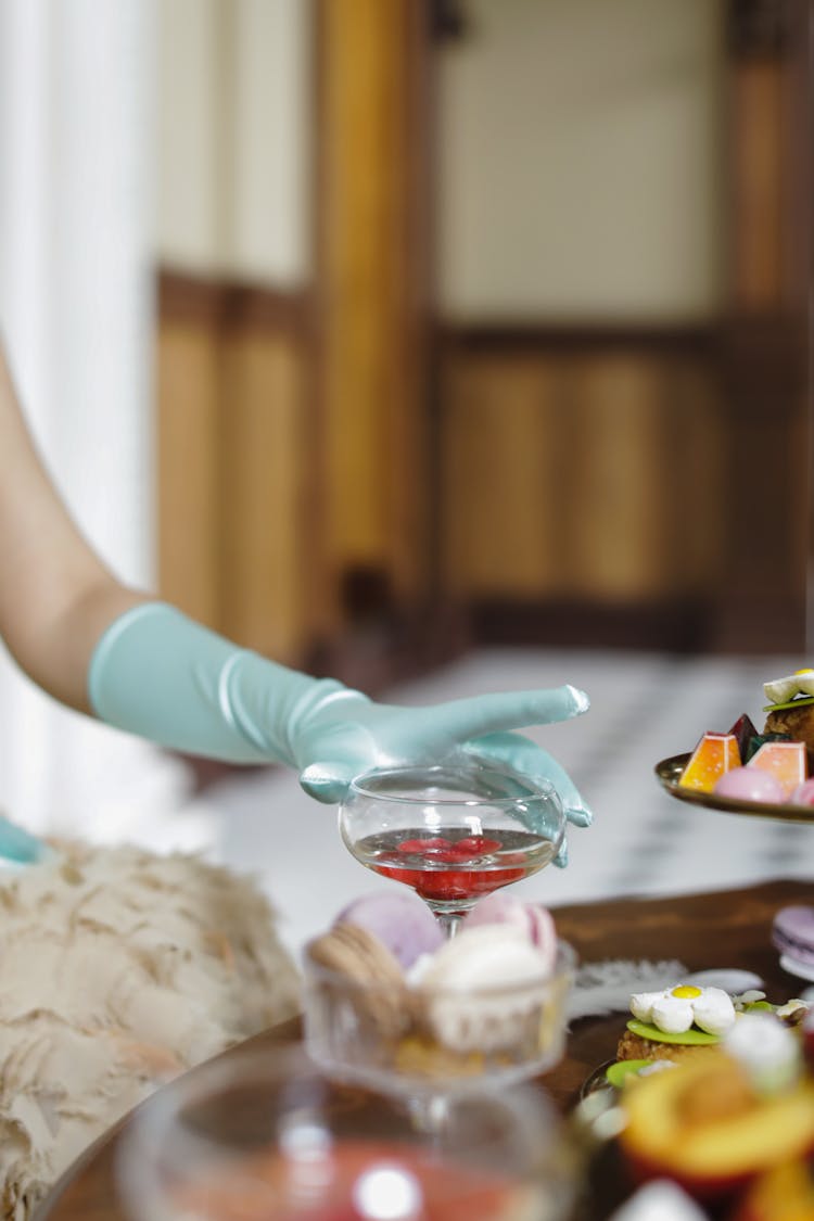 Hand Wearing Satin Glove Holding A Wine Glass